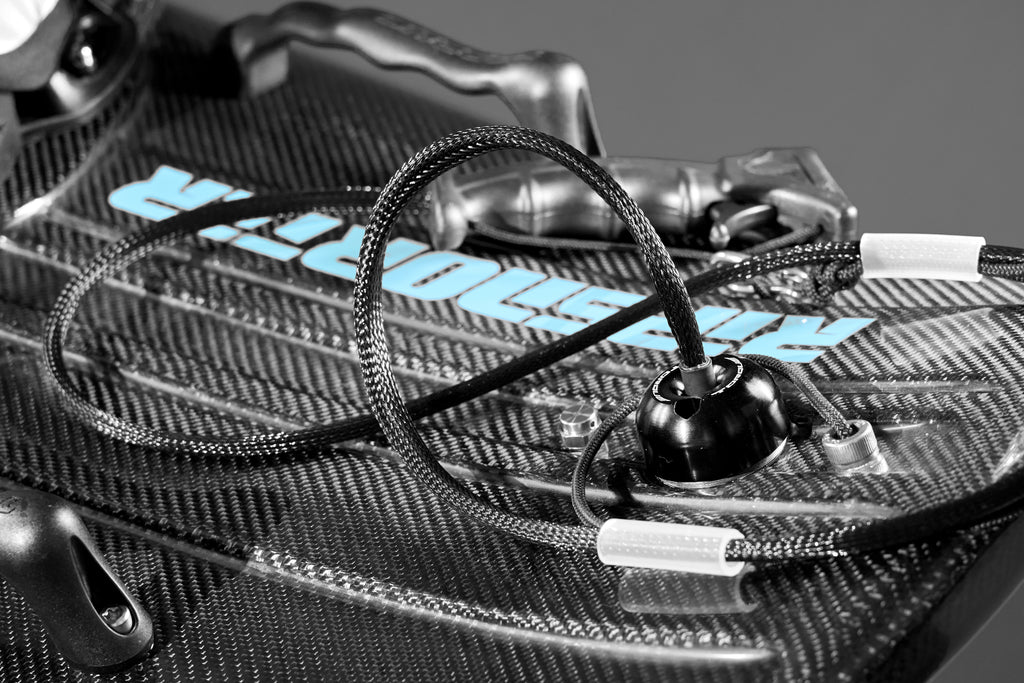 Close-up of the RIPSNORTER FRP electric surfboard showing the handle and cable details.